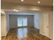Open living room with hardwood floors, neutral paint, and sliding doors to the patio at 1261 Lavista Ne Rd # M-4, Atlanta, GA 30324