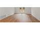Living room featuring wood-grain vinyl flooring, access to the backyard through glass doors, and neutral paint at 1261 Lavista Ne Rd # M-4, Atlanta, GA 30324