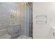 Shower featuring neutral tile, glass doors, and built-in niche for a serene and functional space at 1261 Lavista Ne Rd # M-4, Atlanta, GA 30324
