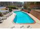 Large community pool with ample lounge chairs, a safety fence, and a brick border at 1261 Lavista Ne Rd # M-4, Atlanta, GA 30324