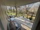 Inviting covered wooden deck overlooking a serene backyard with mature trees and comfortable seating at 7503 E Cherokee Dr, Canton, GA 30115