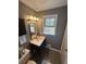 Small bathroom view with vanity, mirror, window, and modern geometric flooring at 7503 E Cherokee Dr, Canton, GA 30115