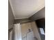 Bright bathroom features a shower with white shower curtain and a small storage cabinet at 7503 E Cherokee Dr, Canton, GA 30115