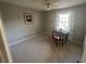 Neutral bedroom boasts a decorative ceiling fan, carpeted floor, and a window with curtains at 7503 E Cherokee Dr, Canton, GA 30115