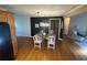 Open-concept dining area featuring hardwood floors and seamless flow to kitchen and stairs at 7503 E Cherokee Dr, Canton, GA 30115