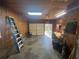 Garage space with open door to outside, features storage cabinets, dart board, and ample storage for projects at 7503 E Cherokee Dr, Canton, GA 30115