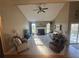 Bright living room featuring a fireplace, vaulted ceiling with fan, and large windows at 7503 E Cherokee Dr, Canton, GA 30115