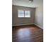 Empty bedroom featuring wood floors and a neutral color scheme at 3153 Lake Monroe Rd, Douglasville, GA 30135