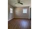 Bright bedroom featuring wood floors, a ceiling fan, and windows for natural light at 3153 Lake Monroe Rd, Douglasville, GA 30135