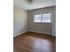 A well-lit bedroom with wood flooring and neutral-toned walls at 3153 Lake Monroe Rd, Douglasville, GA 30135