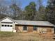 Exterior view of a detached garage or outbuilding needing renovation at 3153 Lake Monroe Rd, Douglasville, GA 30135