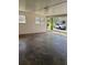 A covered garage with concrete floor and a view of a parked truck outside at 3153 Lake Monroe Rd, Douglasville, GA 30135