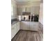 Kitchen featuring wood floors, white cabinetry, granite countertops, and stainless steel oven at 3153 Lake Monroe Rd, Douglasville, GA 30135