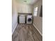 Laundry room featuring a washer, dryer, wood floors, and white storage cabinets at 3153 Lake Monroe Rd, Douglasville, GA 30135