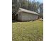 A storage shed or outbuilding situated in a grassy backyard setting at 3153 Lake Monroe Rd, Douglasville, GA 30135