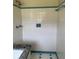 A tiled shower featuring a shower head and functional soap and shampoo holders at 3153 Lake Monroe Rd, Douglasville, GA 30135