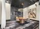 Modern conference room with a round table, unique lighting, and a wall-mounted television at 3324 Peachtree Ne Rd # 1510, Atlanta, GA 30326