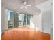 Well-lit room with hardwood floors, ceiling fan, and sliding glass doors to balcony offering city views at 3324 Peachtree Ne Rd # 1510, Atlanta, GA 30326
