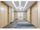 Contemporary hallway with patterned carpet leads to elevator with neutral walls at 3324 Peachtree Ne Rd # 1510, Atlanta, GA 30326