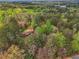 A high-angle view of a home enveloped by dense, mature trees at 738 Lauren Cir, Lawrenceville, GA 30043