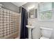 Bathroom includes a shower with patterned tiles, a pedestal sink, and a window at 738 Lauren Cir, Lawrenceville, GA 30043