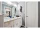 Bathroom features a white vanity and a large mirror with decorative accents at 738 Lauren Cir, Lawrenceville, GA 30043