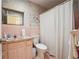 Vintage pink bathroom with a sink, toilet, shower, and storage shelves at 738 Lauren Cir, Lawrenceville, GA 30043