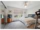 Bedroom with a large bed, treadmill, and natural light from the window at 738 Lauren Cir, Lawrenceville, GA 30043