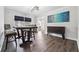 Dining room featuring hardwood floors, a modern light fixture, and a large, colorful painting at 738 Lauren Cir, Lawrenceville, GA 30043