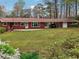 Well-kept lawn and a charming brick house with an attached carport at 738 Lauren Cir, Lawrenceville, GA 30043