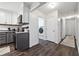 Kitchen with gray cabinets, stainless steel appliances, and an adjacent laundry room and hallway at 738 Lauren Cir, Lawrenceville, GA 30043