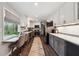 Bright kitchen with breakfast bar, stainless steel appliances, gray cabinets and view of outside at 738 Lauren Cir, Lawrenceville, GA 30043