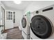 Modern laundry room with front-load washer and dryer, and stylish tile accents at 738 Lauren Cir, Lawrenceville, GA 30043