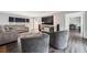 Bright living room featuring hardwood floors, gray furniture, and a large TV at 738 Lauren Cir, Lawrenceville, GA 30043
