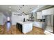 Modern kitchen features stainless appliances, center island with seating, and stylish pendant lighting with hardwood floors at 1102 Morley Se Ave, Atlanta, GA 30312