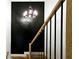 Stairway with wooden railings and black spindles that lead up to the second floor, adjacent to a black accent wall at 1102 Morley Se Ave, Atlanta, GA 30312