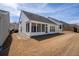 Exterior view of the rear of the house with a screened in porch and a spacious backyard at 1555 Diplomat Dr, Cumming, GA 30041