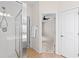 Bathroom with glass door shower and view to bedroom with carpet at 1555 Diplomat Dr, Cumming, GA 30041