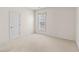 Carpeted bedroom has a window with blinds and a white door at 1555 Diplomat Dr, Cumming, GA 30041