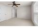 This bedroom has a ceiling fan, a window with blinds, and two doors at 1555 Diplomat Dr, Cumming, GA 30041