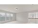 A bright bonus room features neutral carpet, three windows, and a light fixture at 1555 Diplomat Dr, Cumming, GA 30041