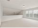 This open bonus room features neutral carpet, three windows, and an overhead light at 1555 Diplomat Dr, Cumming, GA 30041