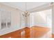Bright dining room with white trim, chandelier, and hardwood floors at 1555 Diplomat Dr, Cumming, GA 30041