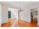 Dining room with hardwood flooring, chandelier, and open doorways at 1555 Diplomat Dr, Cumming, GA 30041