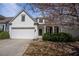Charming white home featuring a well-manicured lawn and blooming tree at 1555 Diplomat Dr, Cumming, GA 30041
