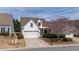Exterior view of a well maintained white home with an attached garage at 1555 Diplomat Dr, Cumming, GA 30041