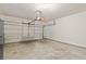 A spacious garage has a garage door and a concrete floor at 1555 Diplomat Dr, Cumming, GA 30041