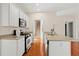 The well-equipped kitchen features stainless appliances and white cabinets at 1555 Diplomat Dr, Cumming, GA 30041