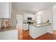 Open kitchen with white cabinetry and hardwood flooring throughout at 1555 Diplomat Dr, Cumming, GA 30041