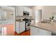 Well-lit kitchen featuring white cabinetry and stainless steel appliances at 1555 Diplomat Dr, Cumming, GA 30041